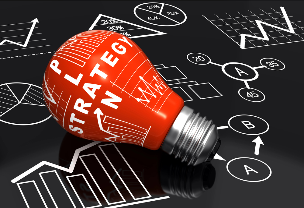 Red light bulb with the words "Plan" and "Strategy" surrounded by charts, graphs, and flow diagrams representing planning and strategic thinking.